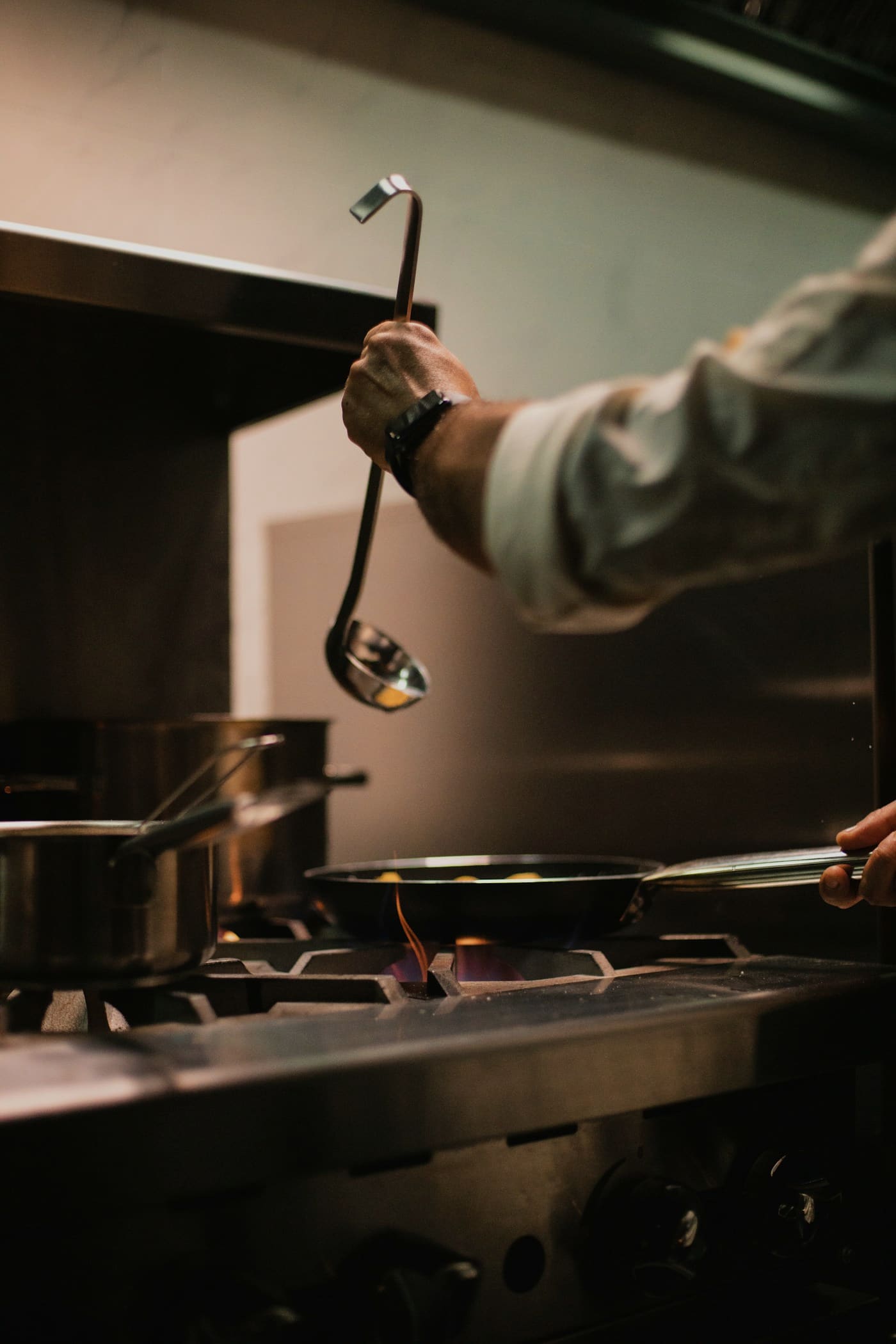 Chef finishing a plated dish of heritage lentils
