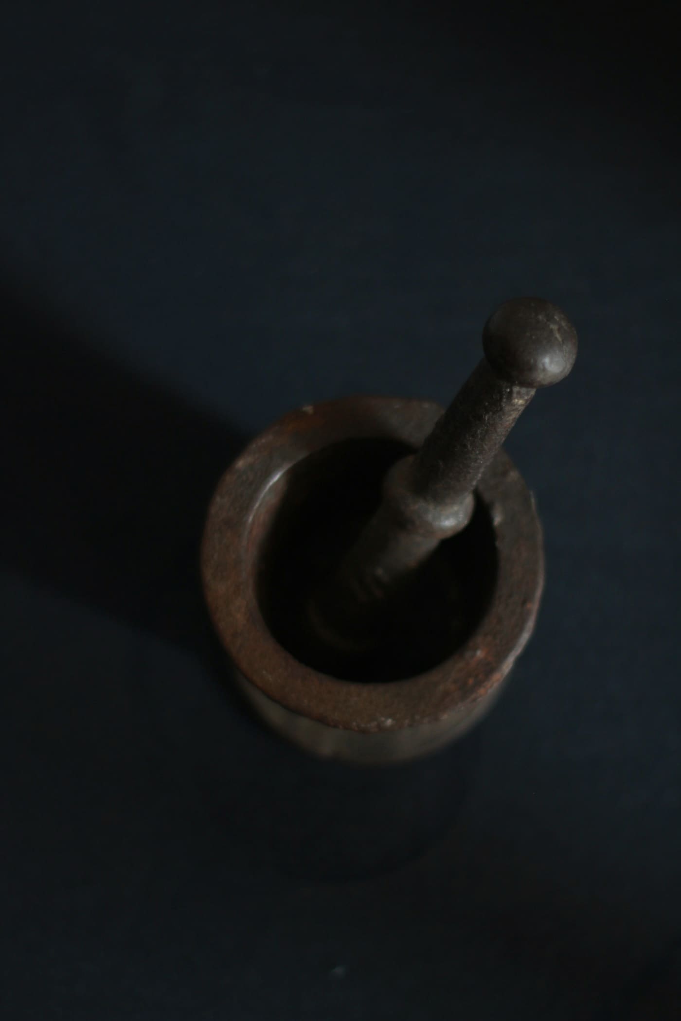 Stone mortar and pestle grinding whole spices